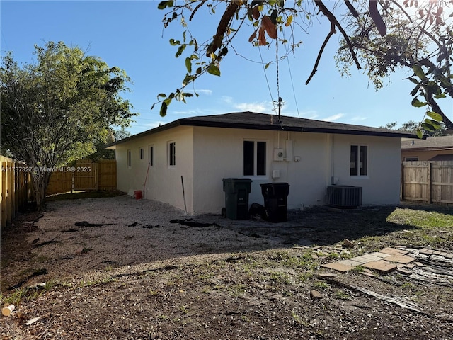 rear view of property featuring central AC unit