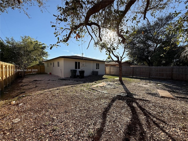 back of property with central AC unit