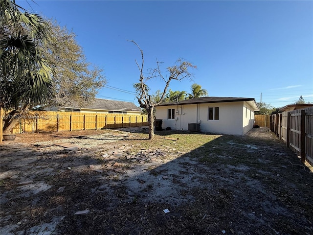 rear view of house featuring central AC