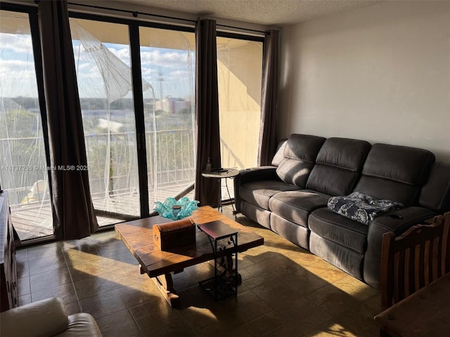 living room with expansive windows and a textured ceiling