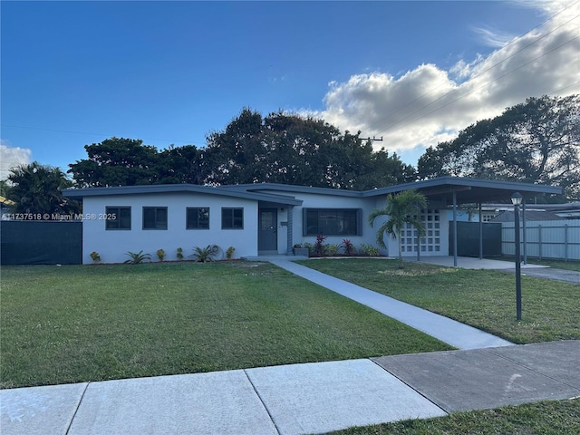 view of front of house with a front lawn and a carport