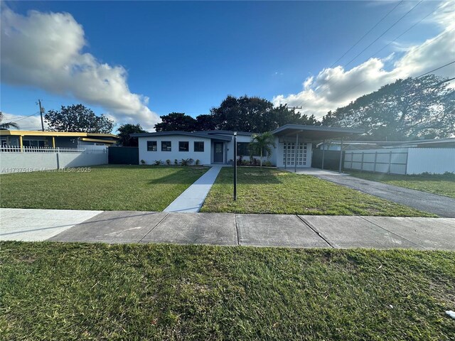 860 NW 171st St, Miami Gardens, FL 33169 - view of front of house featuring a carport and a front yard
