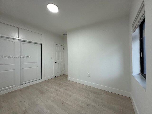 860 NW 171st St, Miami Gardens, FL 33169 - unfurnished bedroom featuring a closet and light hardwood / wood-style flooring