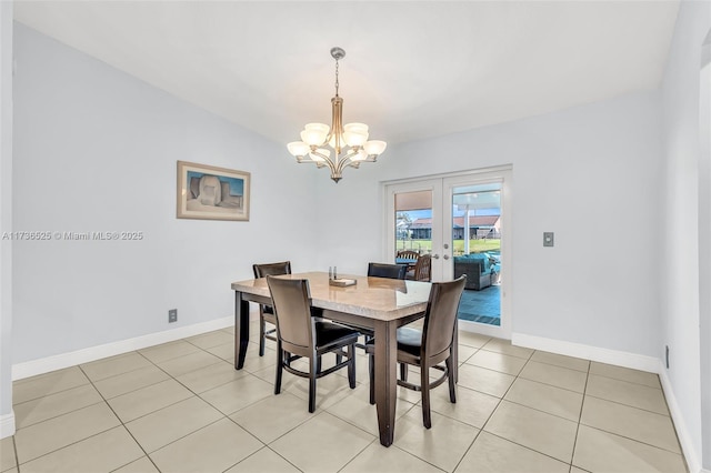 dining area featuring light tile patterned floors, a notable chandelier, and french doors