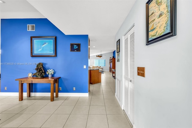 hall with light tile patterned floors