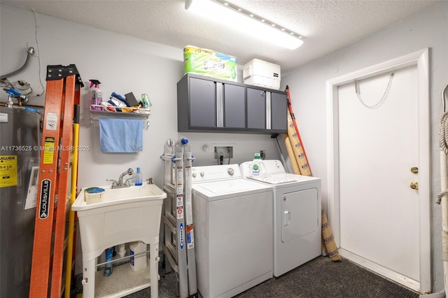 clothes washing area with separate washer and dryer, sink, cabinets, electric water heater, and a textured ceiling