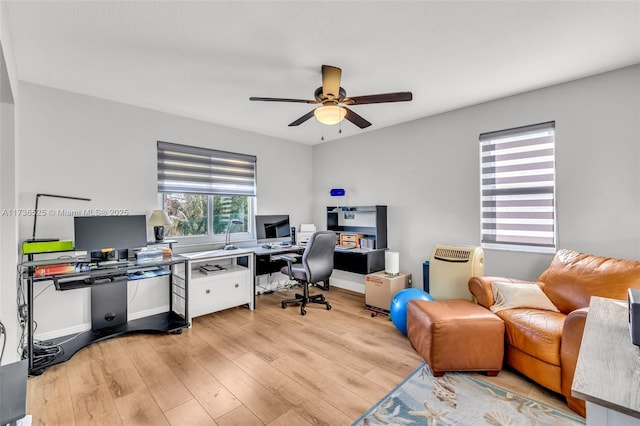 office with ceiling fan and light hardwood / wood-style floors