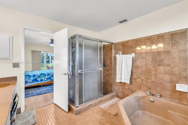 bathroom featuring vanity, tile patterned floors, plus walk in shower, and ceiling fan