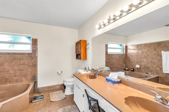 bathroom with toilet, tile patterned floors, a bath, and vanity