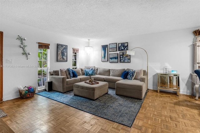 living room featuring parquet flooring and a textured ceiling