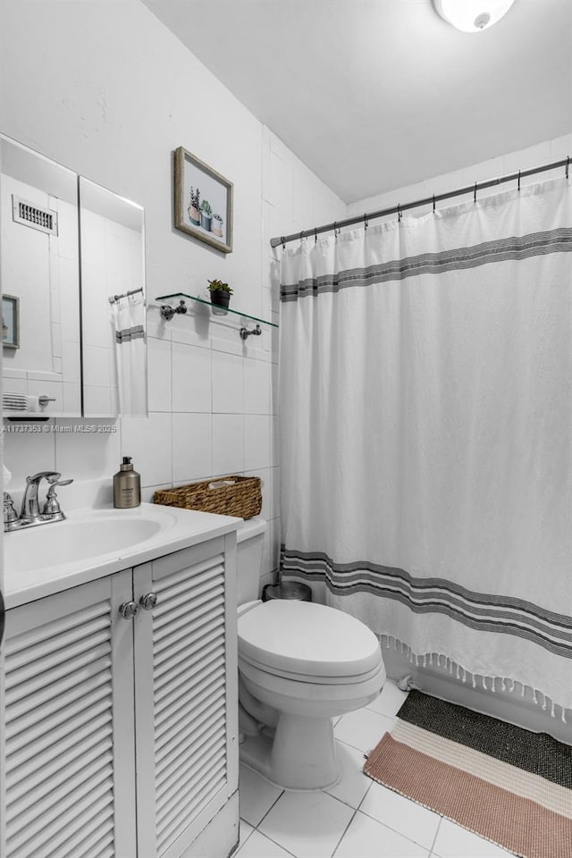 bathroom with tile walls, vanity, curtained shower, and toilet