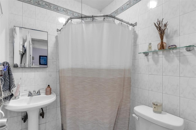 bathroom with tile walls, backsplash, toilet, and walk in shower