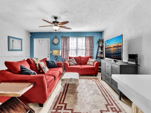 tiled living room featuring ceiling fan and a textured ceiling