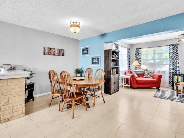 tiled dining area with a textured ceiling