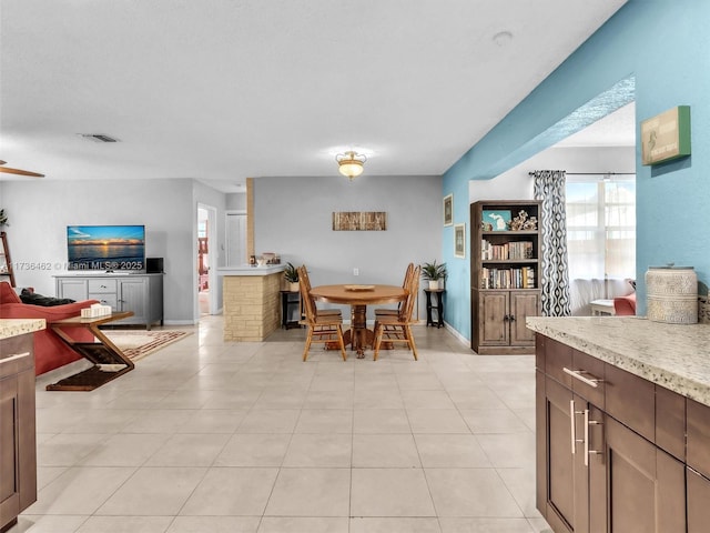 dining space featuring light tile patterned flooring