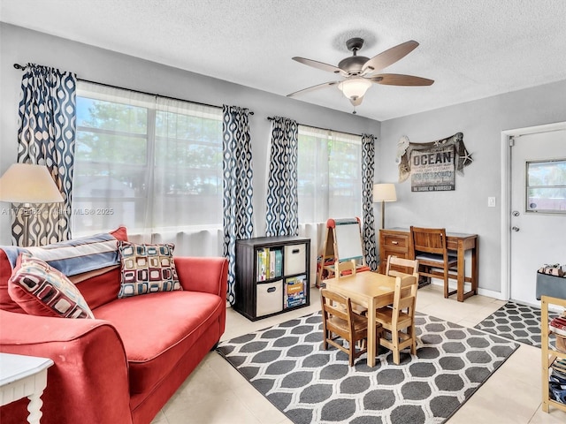 living room featuring a textured ceiling and ceiling fan