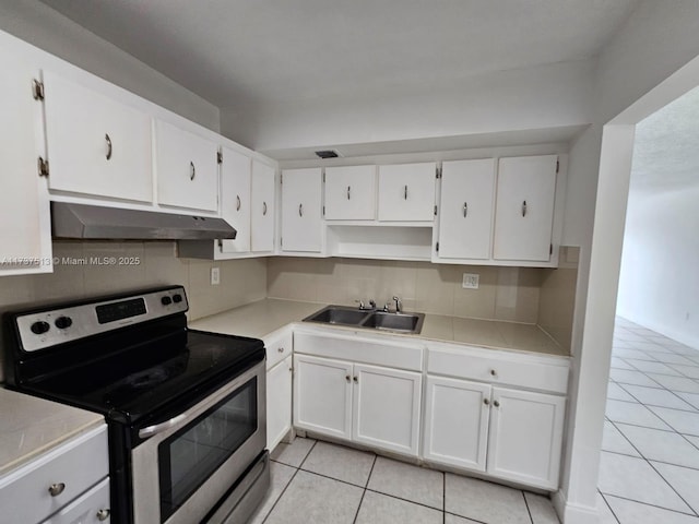 kitchen with white cabinetry, sink, electric range, and backsplash