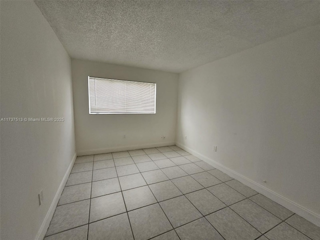 spare room with a textured ceiling