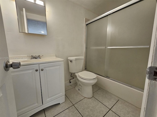 full bathroom with shower / bath combination with glass door, tile patterned floors, toilet, and vanity