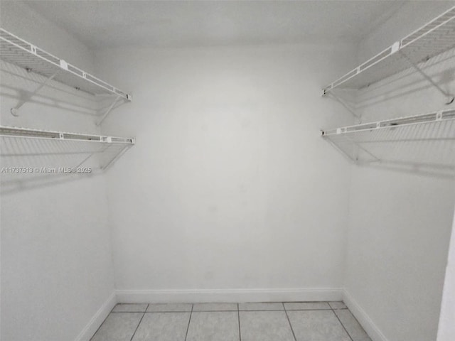 spacious closet featuring tile patterned flooring