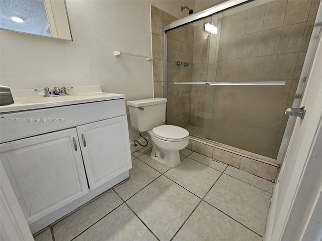 bathroom featuring vanity, toilet, tile patterned floors, and walk in shower