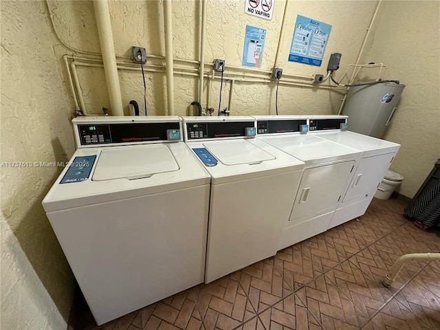 laundry area featuring water heater and washing machine and clothes dryer