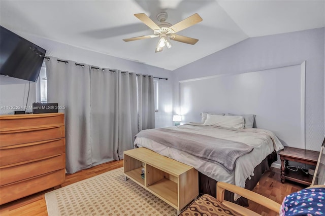 bedroom with lofted ceiling, hardwood / wood-style floors, and ceiling fan