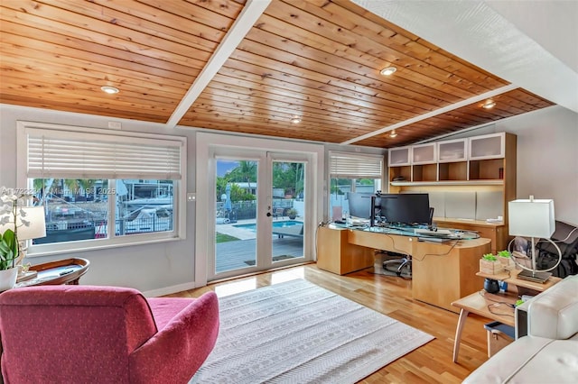 office space with vaulted ceiling, built in desk, wooden ceiling, light wood-type flooring, and french doors