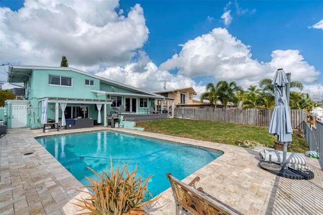 view of pool featuring a yard, an outdoor hangout area, and a patio area