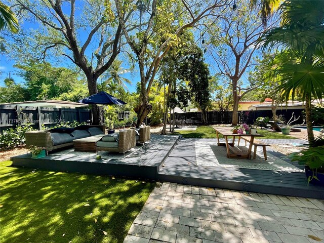 view of home's community featuring an outdoor hangout area and a deck