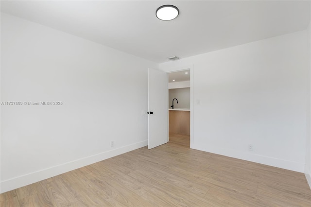 unfurnished room featuring light hardwood / wood-style floors