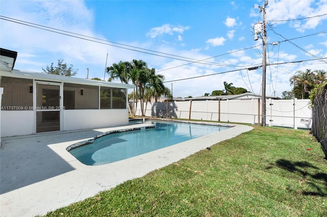 view of swimming pool with a yard, a patio area, and a sunroom