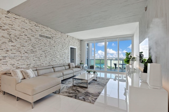 tiled living room with a wall of windows