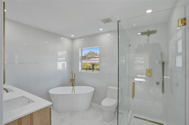 full bathroom featuring independent shower and bath, vanity, tile walls, and toilet