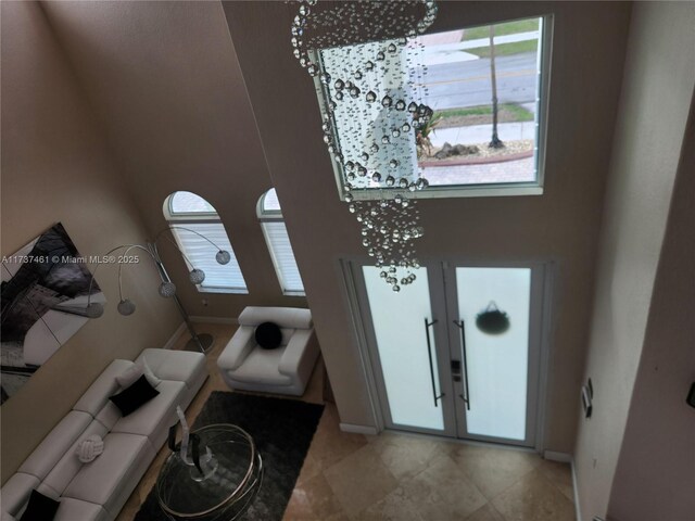 foyer featuring french doors and baseboards