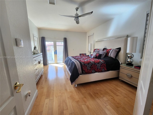bedroom with access to outside, light wood finished floors, visible vents, and a ceiling fan