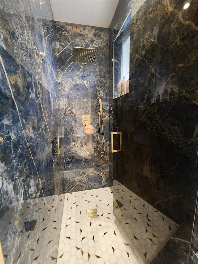 bathroom with a marble finish shower