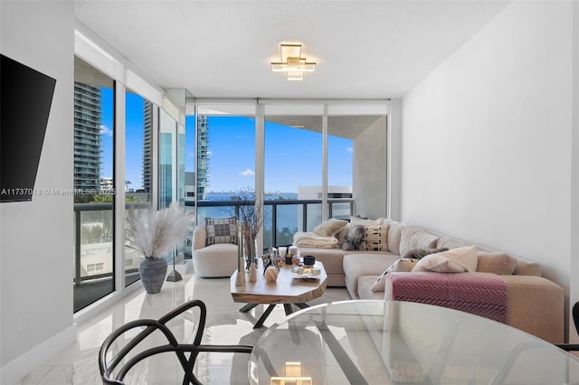 living room featuring expansive windows and a water view