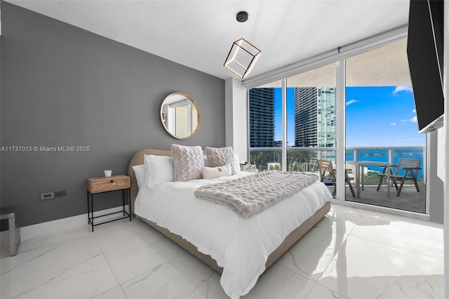 bedroom featuring a wall of windows and multiple windows