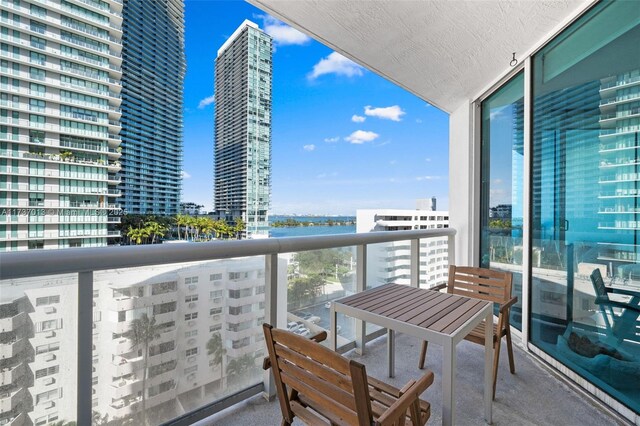 balcony featuring a water view