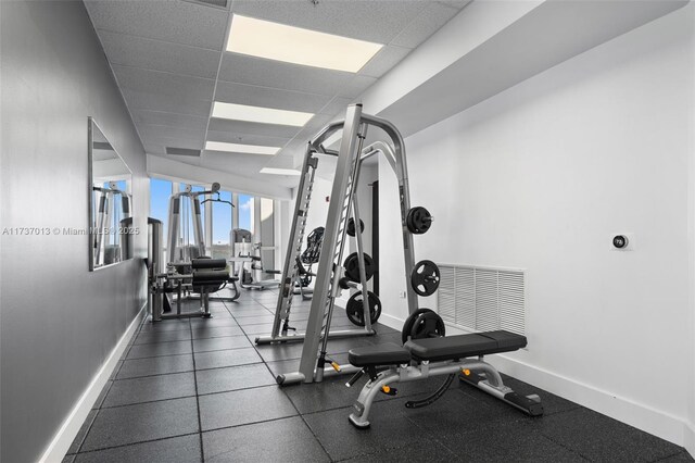 exercise room featuring a paneled ceiling