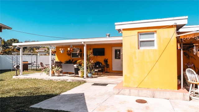 back of property featuring a patio and a lawn