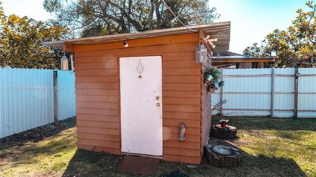 view of outbuilding with a lawn