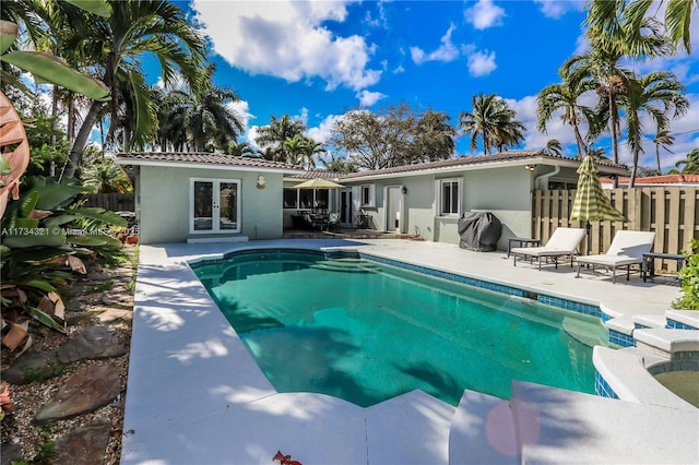 rear view of property with a patio area and french doors