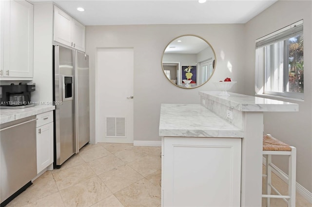 kitchen with white cabinetry and stainless steel fridge with ice dispenser