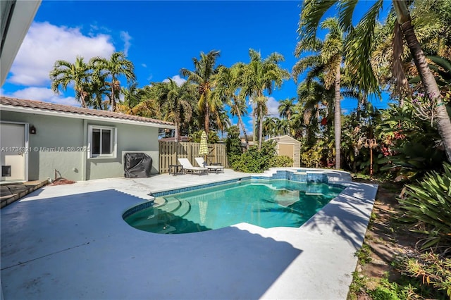 view of pool featuring a patio area and a shed