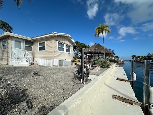 view of side of property with a gazebo and a water view