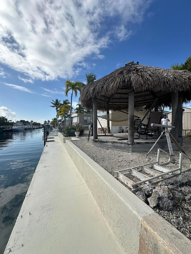 exterior space featuring a water view and a dock