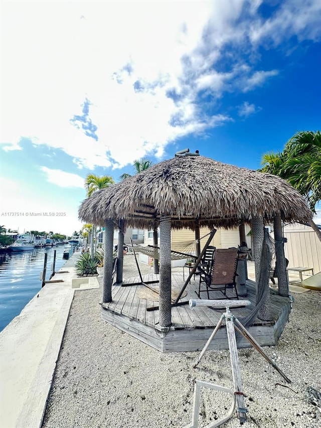 view of patio with a gazebo and a water view