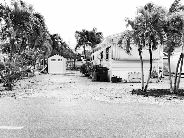 view of home's exterior with an outbuilding and a shed